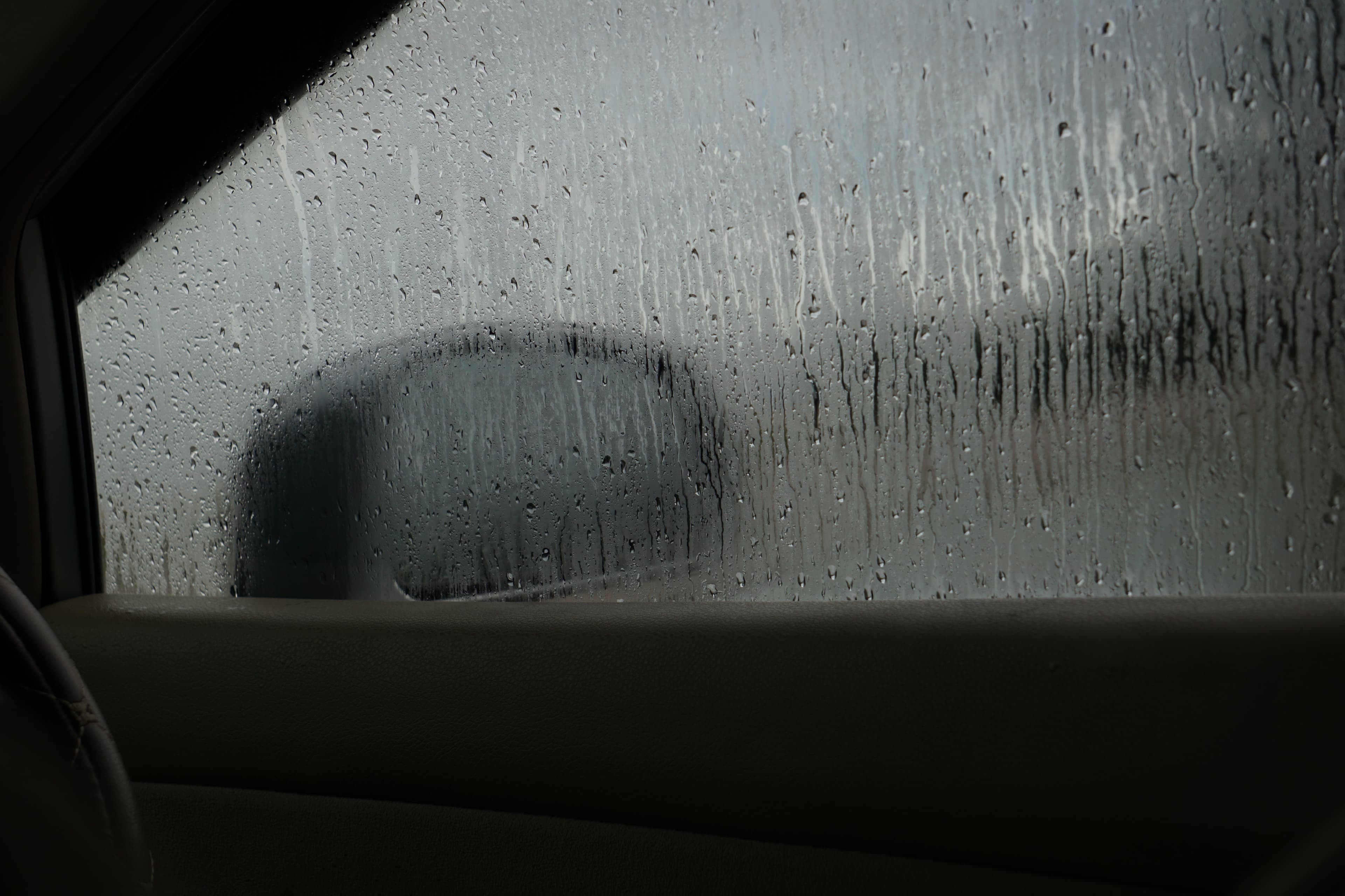 Untreated vehicle side window with dirt and water sheeting